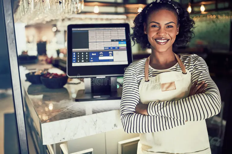 smiling african waitress standing counter restaurant young african waitress wearing apron smiling 113927870